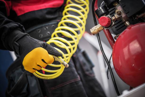 Air Compressor in a Hand. Professional Auto Service Equipment. Air Compressor in a Hand